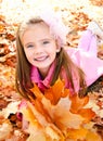 Autumn portrait of cute smiling little girl with maple leaves Royalty Free Stock Photo