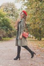 Autumn portrait of happy beautiful woman in red french beret and handbag outdoor Royalty Free Stock Photo