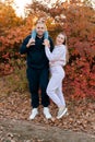 Autumn portrait of a happy family with a small child on a walk in the autumn park, sports mom, dad and son outdoors Royalty Free Stock Photo