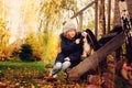 Autumn portrait of happy kid girl playing with her spaniel dog in the garden Royalty Free Stock Photo