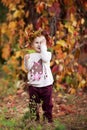 Autumn portrait of little  girl. Pretty little girl with red grape leaves in autumn park. Autumn activities for children. Royalty Free Stock Photo