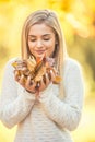 Autumn portrait of young woman with bouquet of maple leaves Royalty Free Stock Photo