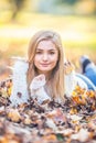 Autumn portrait of young woman lying on maple leaves in park Royalty Free Stock Photo