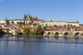 Colorful autumn Prague gothic Castle and Charles Bridge with the Lesser Town in the sunny Day, Czech Republic Royalty Free Stock Photo