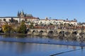 Colorful autumn Prague gothic Castle and Charles Bridge with the Lesser Town in the sunny Day, Czech Republic Royalty Free Stock Photo