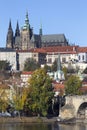 Colorful autumn Prague gothic Castle and Charles Bridge with the Lesser Town in the sunny Day, Czech Republic Royalty Free Stock Photo