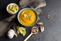 Autumn pumpkin soup in a bowl with fresh garlic, wheat croutons and pepper spices Royalty Free Stock Photo