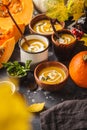 Autumn pumpkin soup puree with cream in cups, the autumn scenery Royalty Free Stock Photo
