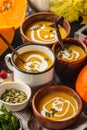 Autumn pumpkin soup puree with cream in cups, the autumn scenery Royalty Free Stock Photo