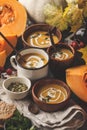 Autumn pumpkin soup puree with cream in cups, the autumn scenery Royalty Free Stock Photo