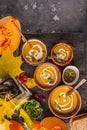 Autumn pumpkin soup puree with cream in cups, the autumn scenery Royalty Free Stock Photo