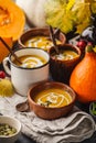 Autumn pumpkin soup puree with cream in cups, the autumn scenery Royalty Free Stock Photo