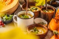 Autumn pumpkin soup puree with cream in cups, the autumn scenery Royalty Free Stock Photo