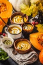 Autumn pumpkin soup puree with cream in cups, the autumn scenery. Healthy vegan food concept Royalty Free Stock Photo