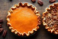 Autumn pumpkin tart and pecan pie on beige background