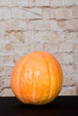 Autumn Pumpkin Thanksgiving Background - orange pumpkins over wooden table. Autumn product. Carved pumpkin for Halloween. Royalty Free Stock Photo