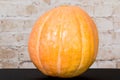 Autumn Pumpkin Thanksgiving Background - orange pumpkins over wooden table. Autumn product. Carved pumpkin for Halloween. Royalty Free Stock Photo