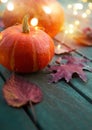 Autumn pumpkins and maple leaves on a wooden background as decorations for thanksgiving day Royalty Free Stock Photo