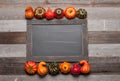 Autumn, pumpkins on old wooden background with copy space on chalkboard Royalty Free Stock Photo