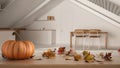 Autumn pumpkins still life on wooden table. Thanksgiving Halloween decoration over interior design scene. Mansard kitchen and