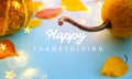 Autumn pumpkins and yellow autumn leaves on light blue background as decorations for thanksgiving day; thanksgiving banner with Royalty Free Stock Photo