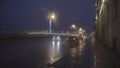 Autumn rainy city street at night, night traffic on wet road during rain, street lights reflected in puddles. Motion