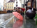Autumn rainy day in city Old Town Of Tallinn ,Estonia, Baltic state 10,08,2019 lifestyle pink umbrella on street people walking