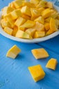 Autumn raw sliced pumpkin on blue wooden background