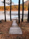 Autumn riverside coast with wooden stairway