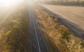 Autumn road in forest drone aerial shot, Overhead view of foliage trees Royalty Free Stock Photo