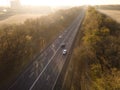 Autumn road in forest drone aerial shot, Overhead view of foliage trees Royalty Free Stock Photo