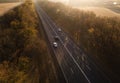 Autumn road in forest drone aerial shot, Overhead view of foliage trees Royalty Free Stock Photo