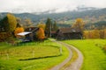 Autumn road over farm grassland in Telemark, Norway Royalty Free Stock Photo