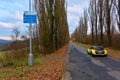 Yellow sport car on old autumn road Royalty Free Stock Photo