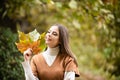 Autumn romance woman with leaves. Female model on foliage day. Dream and lifestyle. Beauty outdoor portrait. Carefree