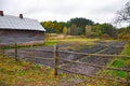 Autumn rural landscape with fence, field, forest and house Royalty Free Stock Photo