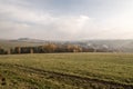 Autumn rural landscape with fields, meadows, village, colorful forest and small hills Royalty Free Stock Photo