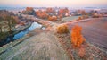 Autumn rural landscape. Frost on grass. River, field, meadow, village, fall color trees Royalty Free Stock Photo