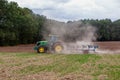 Autumn rural landscape. A modern tractor works in the field.