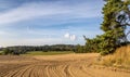 Autumn rural landscape with ruts in plowed field Royalty Free Stock Photo