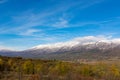 Autumn\'s Majesty: Gilded Trees and Snow-Capped Peaks Royalty Free Stock Photo