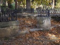 autumn sadness, bucolic image of a lonely fountain with brown leaves on the ground. Concept of sadness and melancholy.