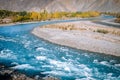 Autumn scene in Gupis. Turquoise blue water of Gilgit river flowing through Ghizer. Pakistan. Royalty Free Stock Photo