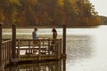 Autumn scene by lake little Seneca with two men on pier Royalty Free Stock Photo