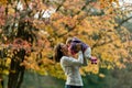 Autumn scene of mother kissing young baby girl outdoors Royalty Free Stock Photo