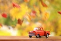 Old orange truck surounded by falling leaves Royalty Free Stock Photo