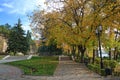 Autumn scene in a public park with falling golden leaves Royalty Free Stock Photo