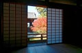 Autumn scenery of a beautiful courtyard garden with a fiery maple tree behind the sliding screen doors Royalty Free Stock Photo