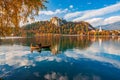 Autumn scenery on Bled lake, Slovenia. Romantic couple sailing by boat Royalty Free Stock Photo