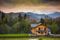 Autumn scenery in Bucovina with wooden cabin at sunset